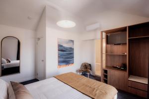 a bedroom with a large bed and a television at Shipwrights Arms Hotel in Hobart