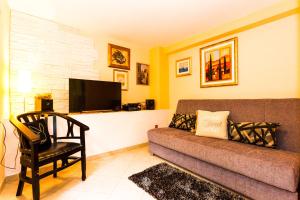 a living room with a couch and a tv at Holiday Home Villa Pindo in Ston