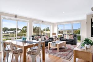 a living room with a couch and a table at The Dunes 1 - BYO Linen in Apollo Bay