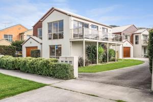 a large white house with glass windows at The Dunes 1 - BYO Linen in Apollo Bay