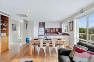 a kitchen and living room with a table and chairs at The Dunes 1 - BYO Linen in Apollo Bay +10 photos