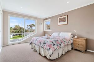 a bedroom with a bed and a window at The Dunes 1 - BYO Linen in Apollo Bay