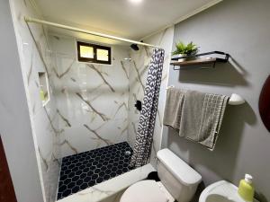 a bathroom with a shower and a toilet at Brisa Del Mar in Playa Hermosa +70 photos
