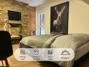 a bedroom with a picture of a deer on the wall at Studio Chalet des Pistes in Gérardmer