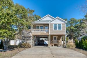 a home with a wrap around porch at Ocean Dream in Kill Devil Hills