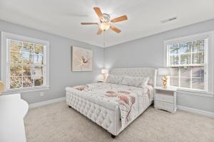 a bedroom with a bed and a ceiling fan at Ocean Dream in Kill Devil Hills