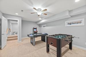 a game room with a table and a game console at Ocean Dream in Kill Devil Hills