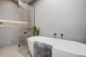 a bathroom with a tub and a glass shower at The Reserve on Wooing Tree in Cromwell +29 photos