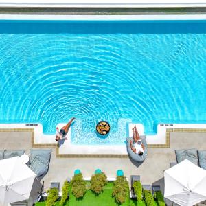 an overhead view of a pool with people swimming in the water at Chalong Marina Bay View Phuket in Rawai Beach +116 photos