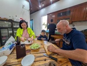 a man and a woman sitting at a table eating food at Tam Coc Gold Smile Homestay in Vũ Lâm +70 photos
