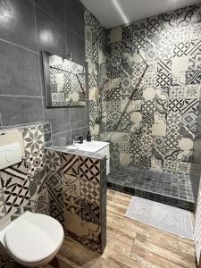 a bathroom with a toilet and a sink and a shower at Loccitan appartement avec local à vélo in Capestang +26 photos
