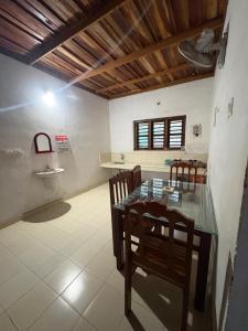 a kitchen with a table and chairs in a room at flamingos home stay in Padinjarathara