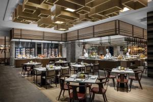 a rendering of a restaurant with tables and a kitchen at Shanghai Marriott Hotel Kangqiao in Shanghai
