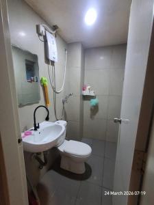 a bathroom with a toilet and a sink and a shower at D Kristal Apartment in Semenyih