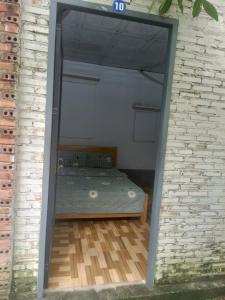 a bedroom with a bed inside of a brick wall at Homestay Phố biển cam bình in Lagi +5 photos