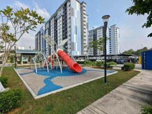 a playground with a slide in a park at D Kristal Apartment in Semenyih