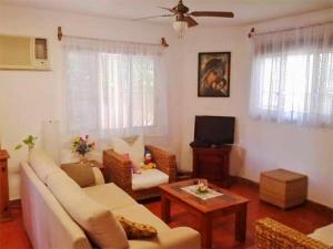 a living room with a couch and a table at Los Caracoles Bed & Breakfast in Cancún