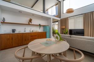 a living room with a table and a couch at Sea Escapes Villas in Thong Sala