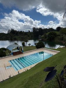 a large swimming pool next to a river at Finca María Bonita in Horizonte