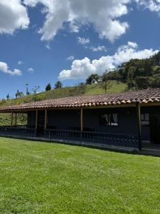 a building with a grassy field in front of it at Finca María Bonita in Horizonte