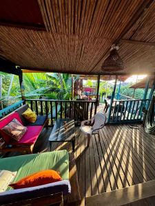 a living room with a couch and a table on a deck at La Roca House in El Valle