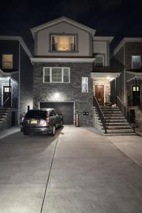 a car parked in front of a house at night at Chic & Comfy Apartment in Elizabethport