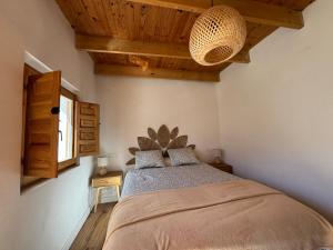 a bedroom with a large bed with a wooden ceiling at La Casa de Célia in Valencia de Don Juan +53 photos