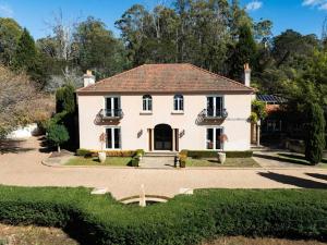 a large white house with a driveway at Villa Donini in Riverside