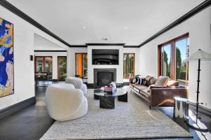 a living room with leather furniture and a fireplace at Villa Donini in Riverside