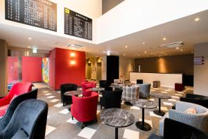 a restaurant with tables and chairs and a menu at KOKO HOTEL Hakata Station in Fukuoka