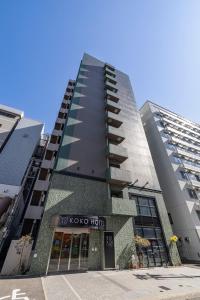 a tall building with a sign that reads koko hotel at KOKO HOTEL Hakata Station in Fukuoka