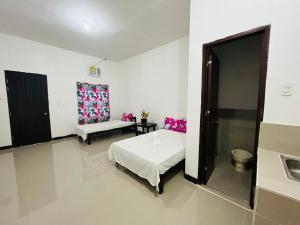 a bedroom with a bed and a toilet in it at ChicPoint Guesthouse in Sampong