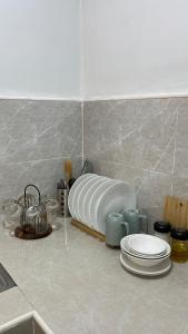a kitchen counter with plates on a counter top at Solara Villa, Gensan in General Santos +8 photos