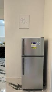a silver refrigerator in a room with a picture on the wall at Solara Villa, Gensan in General Santos