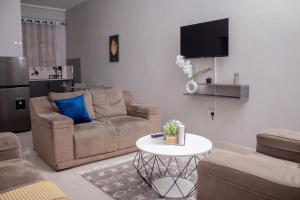 a living room with a couch and a table at The Views Apartments in Kariba