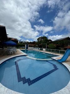 a large swimming pool with blue tiles on it at Privê Refúgio Gravatá in Gravatá