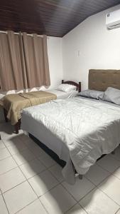 a bedroom with two beds and a window at Privê Refúgio Gravatá in Gravatá +56 photos