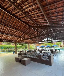 a pavilion with tables and chairs and blue umbrellas at Privê Refúgio Gravatá in Gravatá