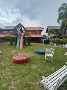 a park with a bench and some inflatableitures at Privê Refúgio Gravatá in Gravatá