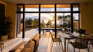 a living room with a couch and a table at Morris Resort Tohginbow in Sakai