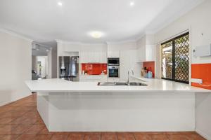 a large white kitchen with a large white counter top at Spacious 4BR Waterfront Stay Pool Table AC in Newport