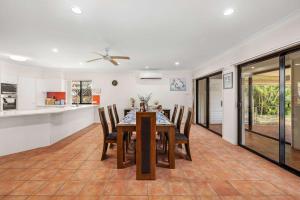 a dining room and kitchen with a table and chairs at Spacious 4BR Waterfront Stay Pool Table AC in Newport +16 photos