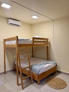 two bunk beds in a room with a air conditioner at Islas Boho Tiny Home - Main strip El Tunco in El Sunzal