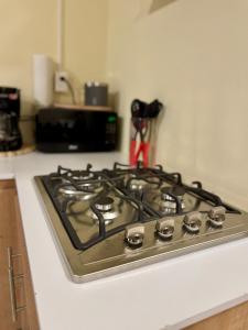a stove top oven sitting on top of a kitchen counter at Islas Boho Tiny Home - Main strip El Tunco in El Sunzal