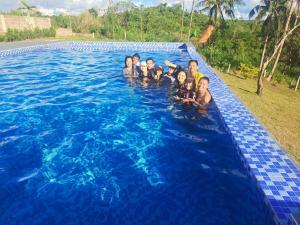a group of people in a swimming pool at Mccp glamping and resort in Cavinti