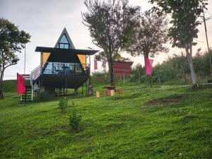 a playground in a field with a gazebo at Mccp glamping and resort in Cavinti