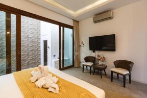 a hotel room with a bed with a towel at Unique Lanna Style Spa Pool Villa in Chiang Mai