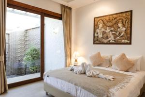 a bedroom with a bed with a painting on the wall at Unique Lanna Style Spa Pool Villa in Chiang Mai +72 photos