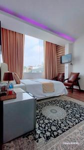 a bedroom with a large bed and a large window at Khách sạn Thy Thảo 3 in Ho Chi Minh City +20 photos