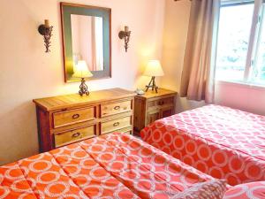 a bedroom with two beds and a dresser and a mirror at Right on Main St Hot Tub Close to Marina Garage in Frisco